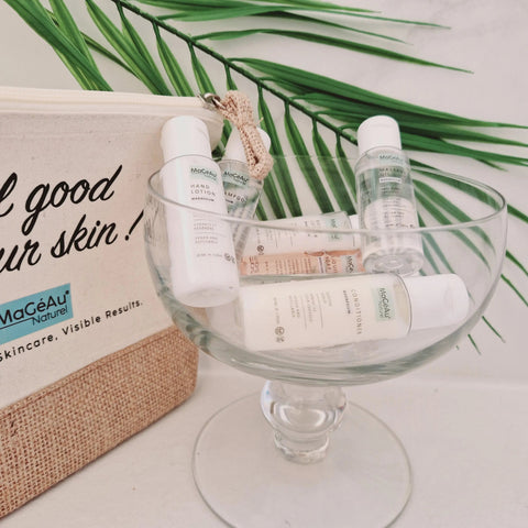 Skincare products on a glass dish with a branded bag in the background