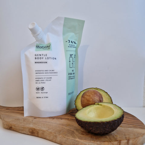 Mageau naturel magnesium Gentle Body Lotion next to an avocado on a wooden board
