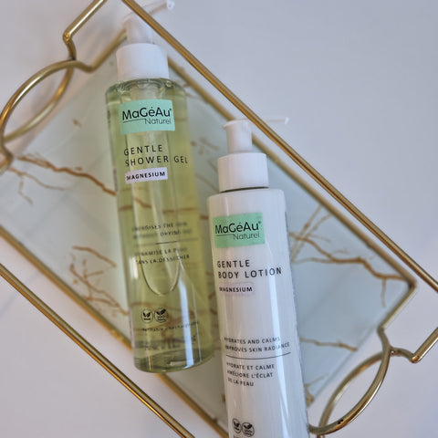 Three bottles of Mageau naturel magnesium skincare products on a decorative tray with a marble background.