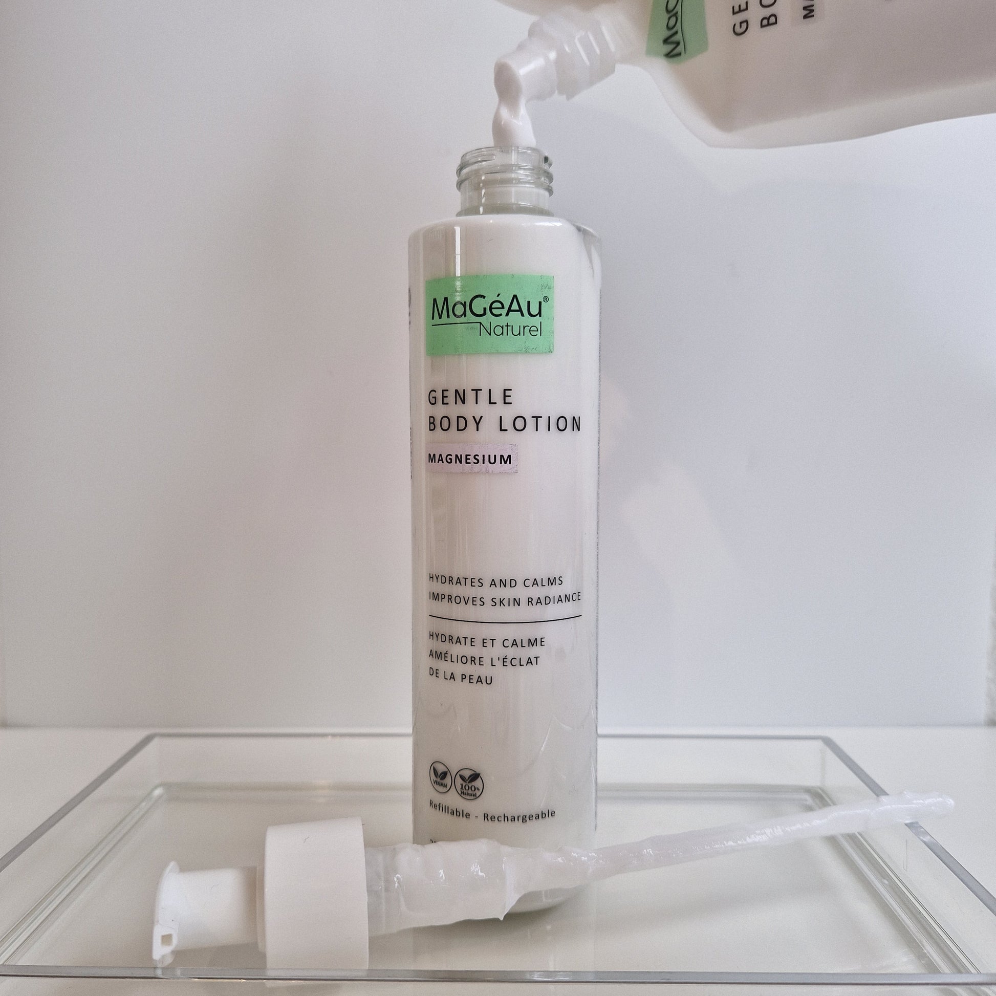 MaGéAu Naturel Gentle Body Lotion being applied with a pump on a white background