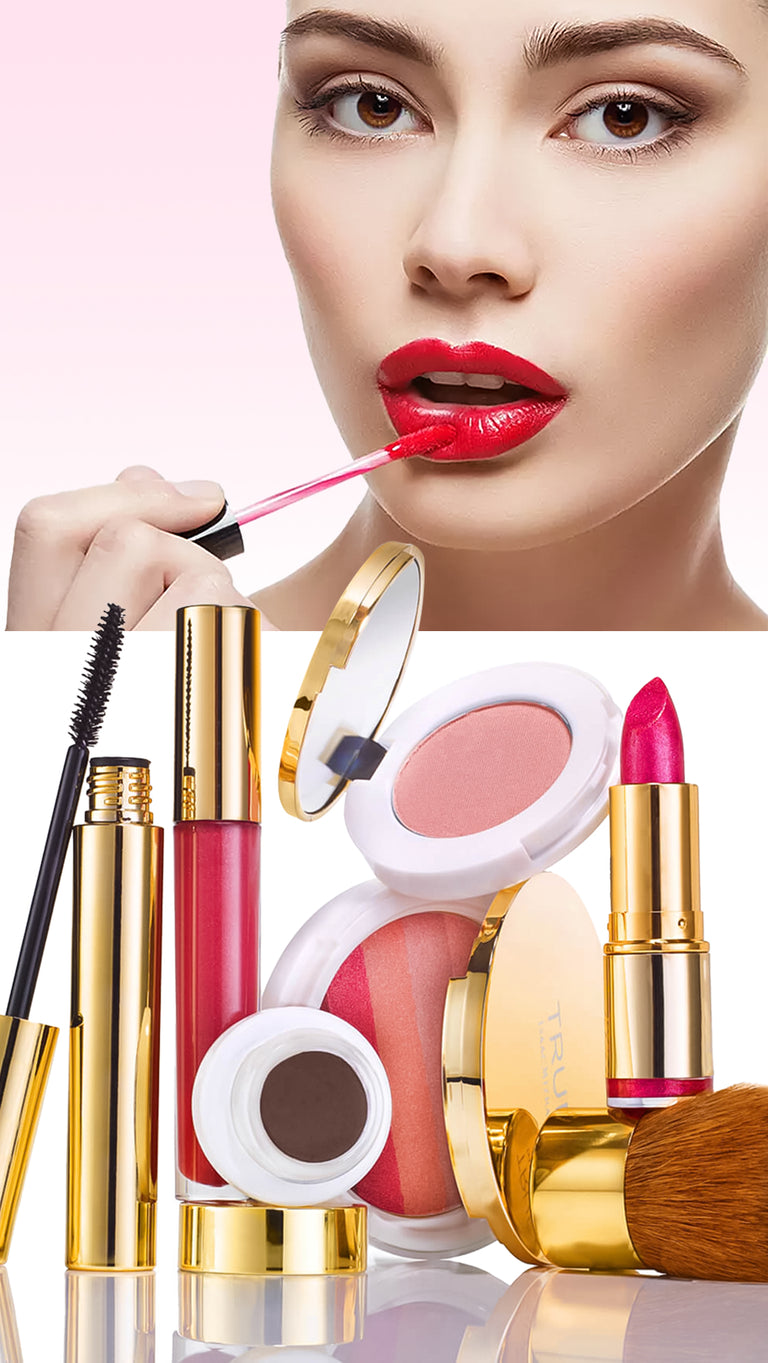 Makeup products including lipsticks, blush, and mascara on a reflective surface with a pink background.